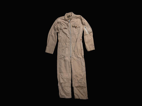 Commander William B. Ecker wore this US Navy flight suit during a reconnaissance flight over Cuba in October 1962 during the Cuban Missile Crisis. Studio photography of flight suit against black background.